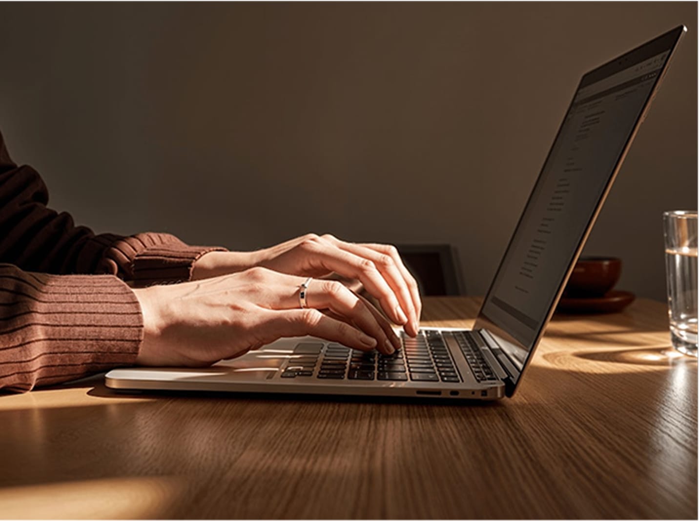 A photo showing hands typing on a laptop keyboard.